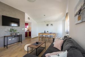 a living room with a couch and a table at APARTMANI BEBA in Omišalj