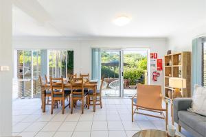a living room with a dining room table and chairs at Fingal Bay Coastal Retreat 1 12 Marine Dr fantastic ground floor duplex in Fingal Bay