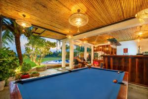 a pool table in the middle of a living room at Sunkised Paddy Hoi An Villa in Hoi An