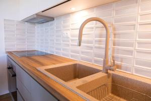 a kitchen sink with a faucet on top of it at SeaeyeVillas 2 in Livadi