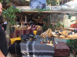 a woman standing in front of a table with bread at Tiki garden in Kampot