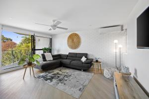 a living room with a couch and a table at Beachside Views 2 Bedroom Apartments Mooloolaba in Mooloolaba