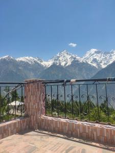 a balcony with a view of snow covered mountains at Aaruhee Homestay in Kalpa