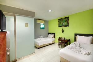 Postel nebo postele na pokoji v ubytování Negara Hotel - CHSE Certified + 37 fotografií