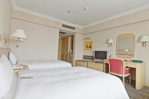 Voodi või voodid majutusasutuse Santos Hotel toas