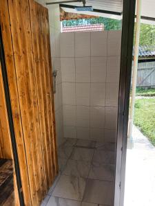 a shower stall in a house with a sliding door at Camping Ciungani in Ciungani