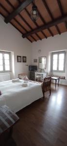 a large bedroom with a large bed and a table at Il Casale di Giulia di Aprilia in Aprilia