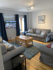 a living room with a couch and a coffee table at The Crail Maltings in Crail