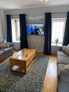 a living room with a couch and a coffee table at The Crail Maltings in Crail