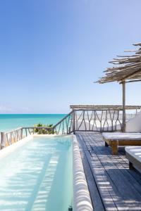 a swimming pool with a view of the ocean at Punta Blanca Beach House in Costa Mujeres