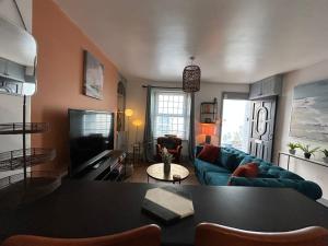 a living room with a couch and a table at Fully Equipped Devon 2BR Cottage in Teignmouth