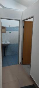baño con lavabo y puerta de cristal en NTC Homestay at Parit Buntar en Parit Buntar