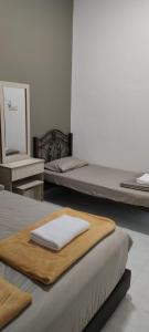 Katil atau katil-katil dalam bilik di NTC Homestay at Parit Buntar