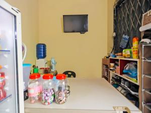 a room with a table with soda bottles on it at SPOT ON 92569 Anto Homestay Syariah in Nagoya