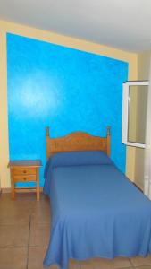 Postel nebo postele na pokoji v ubytování Hostal Poncebos