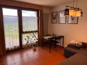 a living room with a table and a window at Chalet bellevue in Asiago