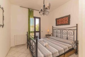 a bedroom with a bed with towels on it at Trilo Debora 2Km From The Beach - Happy Rentals in Porto San Paolo