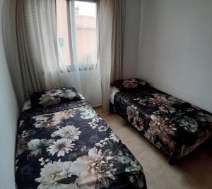 1 dormitorio con 2 camas y ventana en Urban Altos Del Sol, en Torrevieja