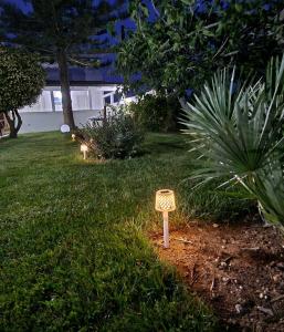a garden with two signs in the grass at Meraviglia d'Otranto in Otranto