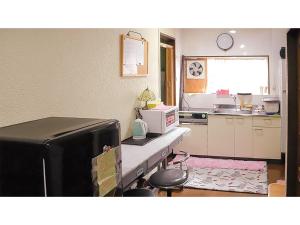 a kitchen with a sink and a counter with a microwave at Kyoto - Hotel / Vacation STAY 36511 in Kyoto