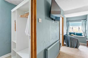 a living room with a flat screen tv on a wall at Bellamarsh Farm B&B in Newton Abbot