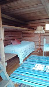a bedroom with a bed in a log cabin at Reittiö B&B in Sulkava