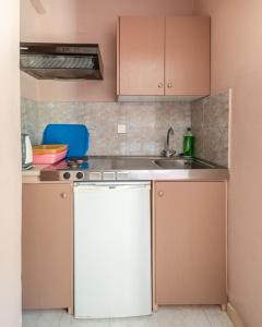 a kitchen with a sink and a white dishwasher at Fantastic Matala 1 in Matala