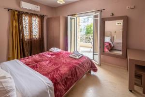 a bedroom with a large bed and a mirror at Fantastic Matala 1 in Matala