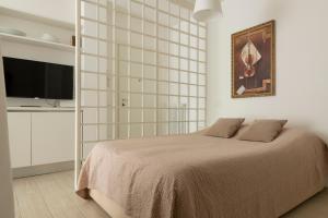 A bed or beds in a room at Casa Aleardi grazioso e nuovissimo monolocale con balcone