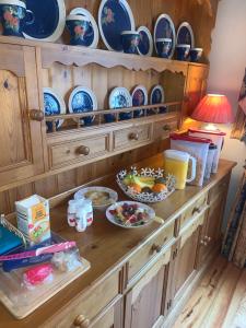 a kitchen counter with bowls and plates on it at The White House B & B in Kenmare