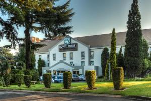 a hotel with a sign on the front of a building at Road Lodge Germiston in Germiston