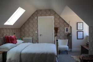 a attic bedroom with a bed and a skylight at Henley-on-Thames in Henley on Thames
