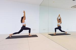 a woman doing a yoga pose in front of a mirror at Villa Blue View Luxe in Mae Nam
