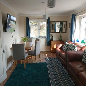 a living room with a couch and a table at Stylish 2 bed flat at Camber Sands in Camber