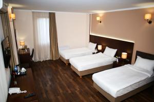 Postel nebo postele na pokoji v ubytování Hotel Corner Inn