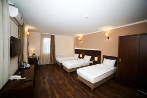 Postel nebo postele na pokoji v ubytování Hotel Corner Inn