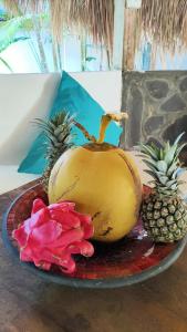 a plate with a banana and pineapple on a table at Tiki Boutique Hotel Lombok in Selong Belanak