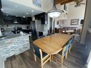 a kitchen and dining room with a wooden table and chairs at Rr-edgewater17 in June Lake