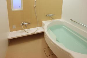 a bathroom with a bath tub and a shower at Tokyo Bay Maihama Hotel in Urayasu