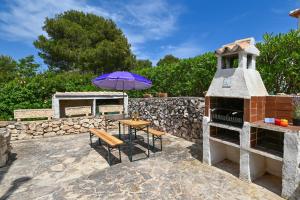 a patio with a table and an umbrella at Pinecrest in Jávea