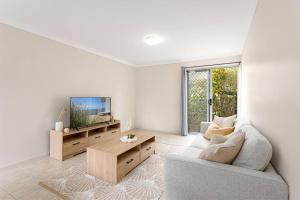 a living room with a couch and a tv at Self-contained unit in Scarborough in Scarborough