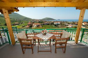 a table and chairs on a balcony with a view at Panorama Plati in Platy