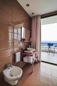 a bathroom with two sinks and a large window at Rapos Resort Hotel in Himare