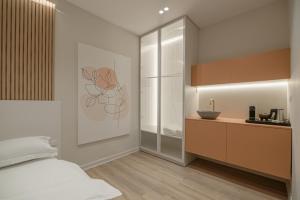 a bedroom with a bed and a kitchen at No125 - City Centre Room Apartment in Orestiada