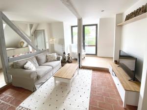 a living room with a couch and a tv at Boutique apartments in Banská Štiavnica