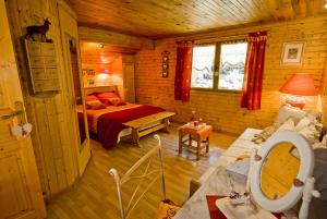 a bedroom with a bed in a log cabin at Chalet la Colombière in Sainte-Agnès