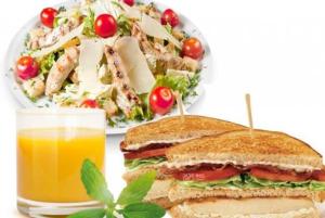 a sandwich and a salad and a glass of orange juice at Herfa INN Hotel Lahore in Lahore