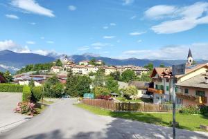 a street in a town with houses and mountains at APPARTAMENTO TOMA MIHAELA in Tres