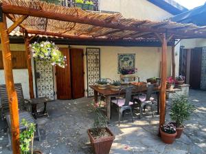a patio with a wooden table and chairs at La Colombaia Amiata in Arcidosso