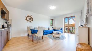 un soggiorno con divano blu e tavolo di Apartamenty Sun & Snow Gdańska II a Krynica Morska